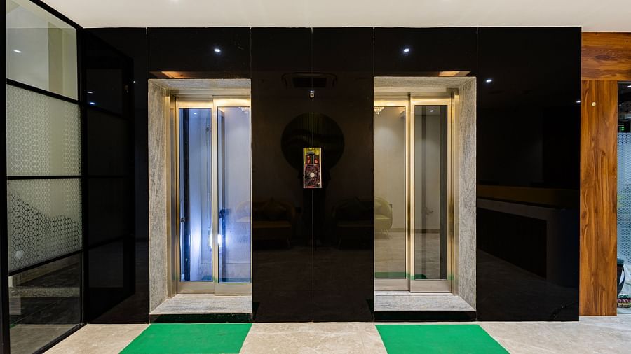 Lemonridge Hotels, KPHB | Modern elevators with mirrored doors and a digital display.  Green mats on the floor.